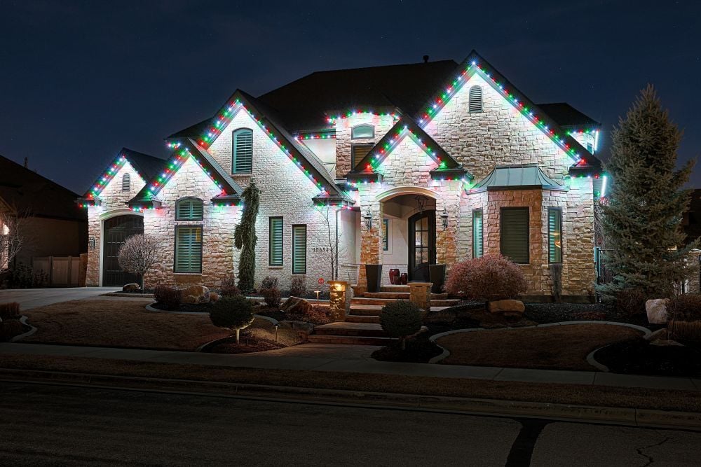 A home that has a full green Trimlight pattern to celebrate the holidays