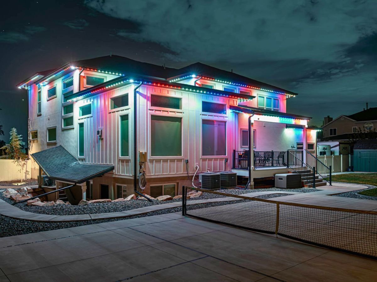 A box like home with a red, white and blue trimlight pattern after the home is installed with trimlight