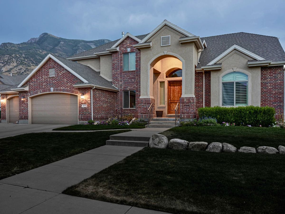 A home with rocks in front and a brick facia