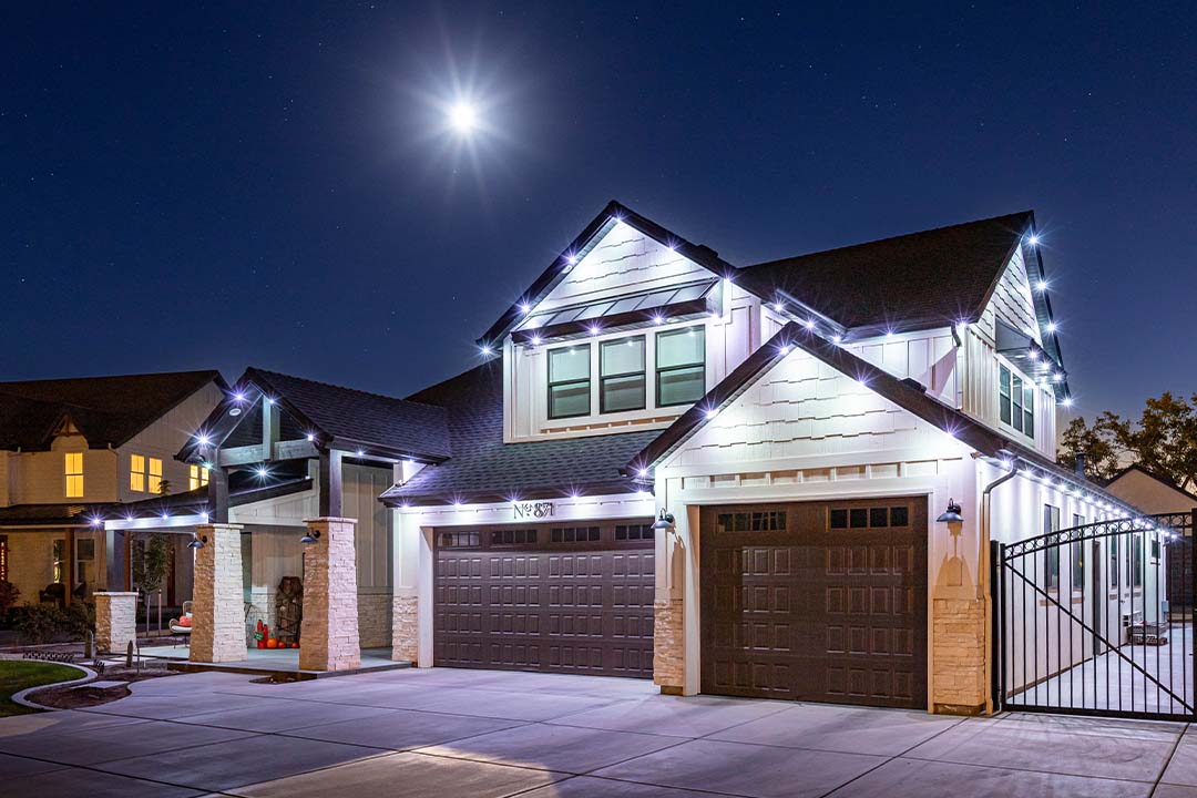 bright security lighting and white trim lighting on home
