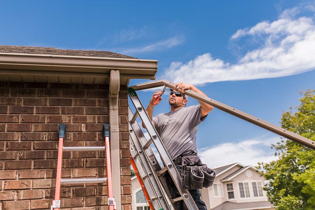 Technician shaping fascia