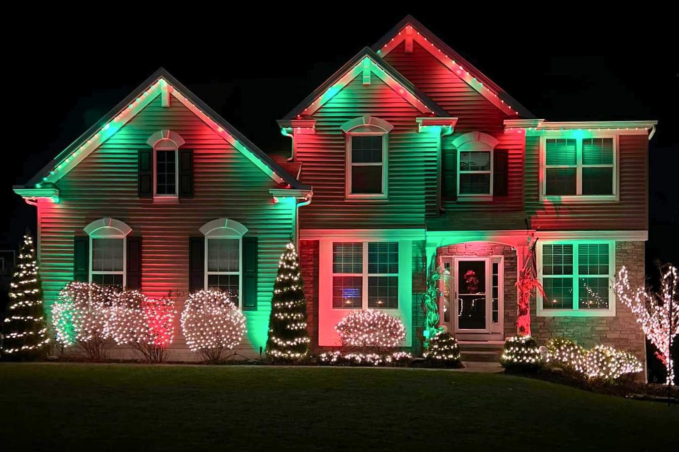 a home with Christmas decorations that features red and green Trimlight LEDs