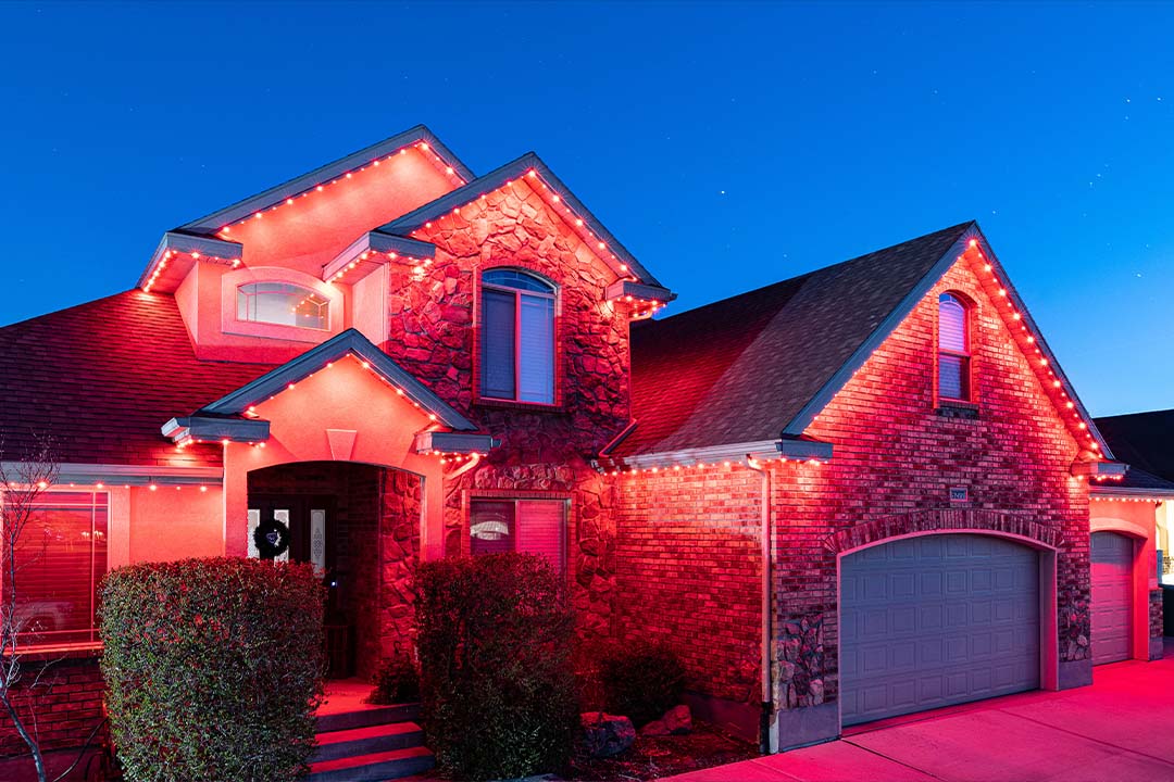 home illuminated with red permanent lighting