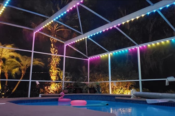 Pastel Easter color pool cage lighting with flamingo inflatable