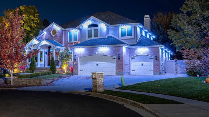 Security accent lighting on light red brick home.