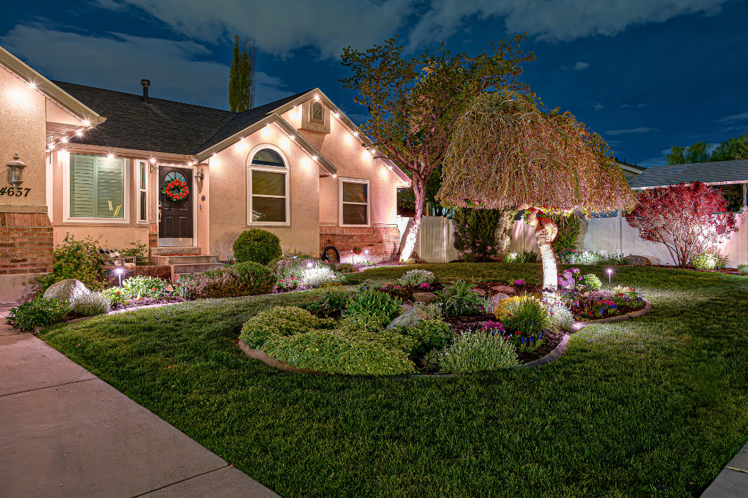 A home that has an accent Trimlight lighting pattern with some white landscape lighting in front of the home.