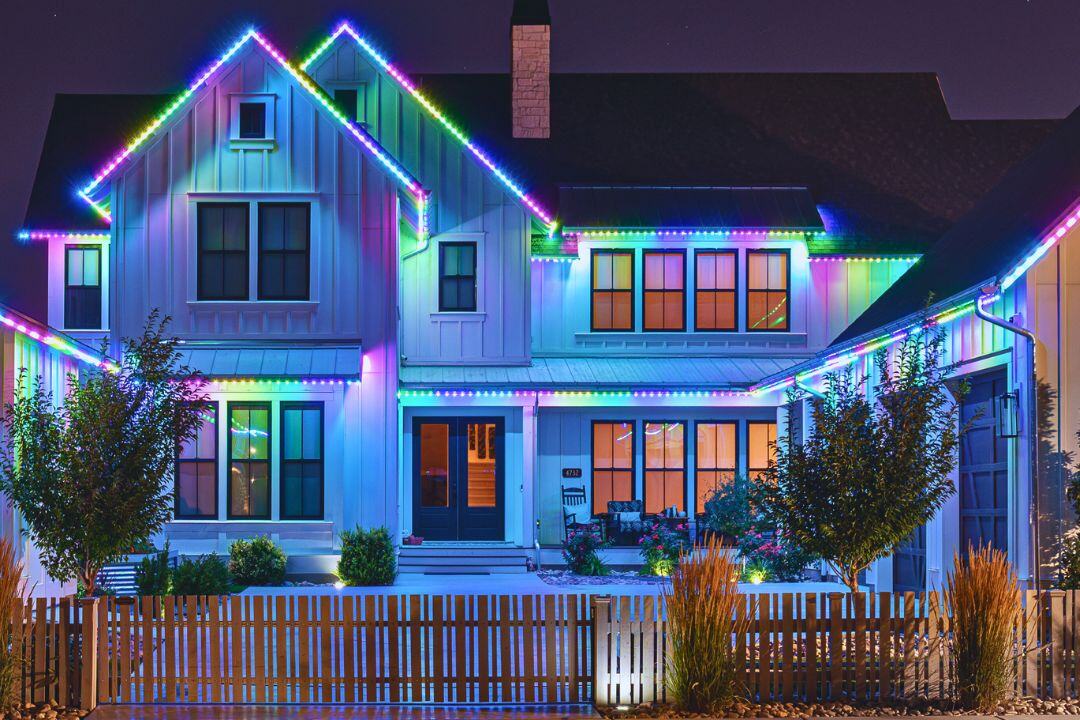 a white modern home with Trimlight on the home featuring a Easter pattern