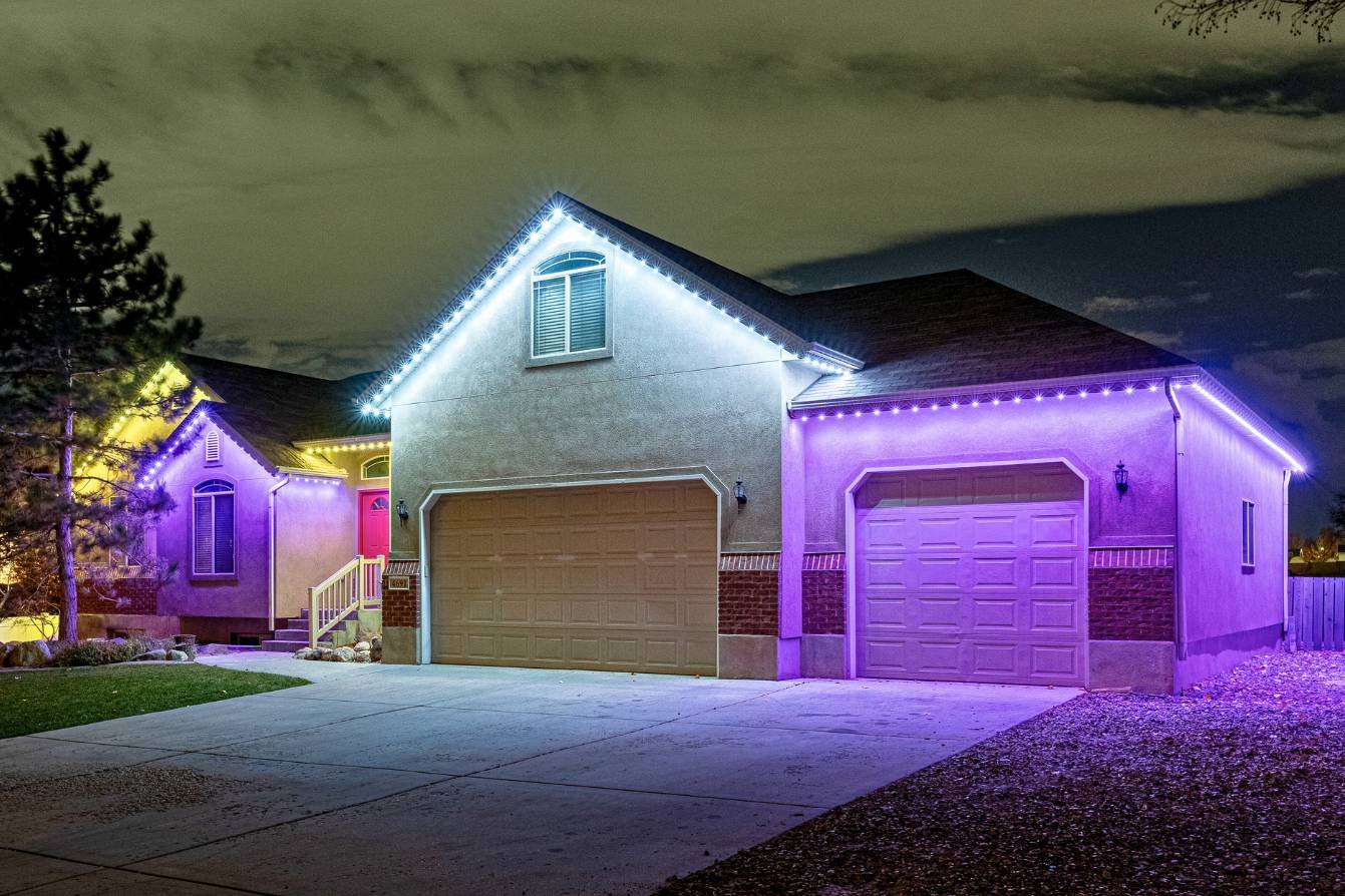 a home with many peaks featuring a game day zoning pattern that purple, white and yellow